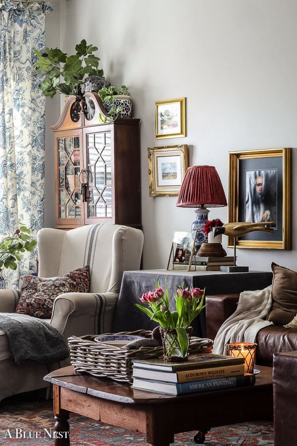 Collected living room with layered neutral decor, vintage accents, and warm textures creating a cozy, lived-in home