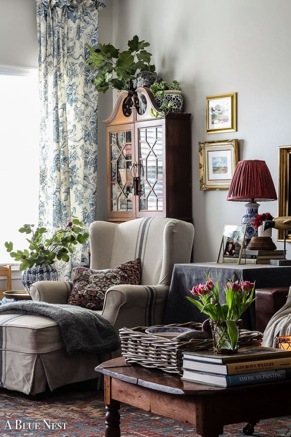 Cozy corner featuring thrifted and secondhand décor in a lived-in home.