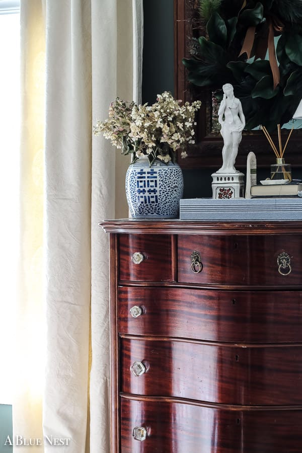 Close-up of solid wood grain and vintage hardware on a secondhand dresser.